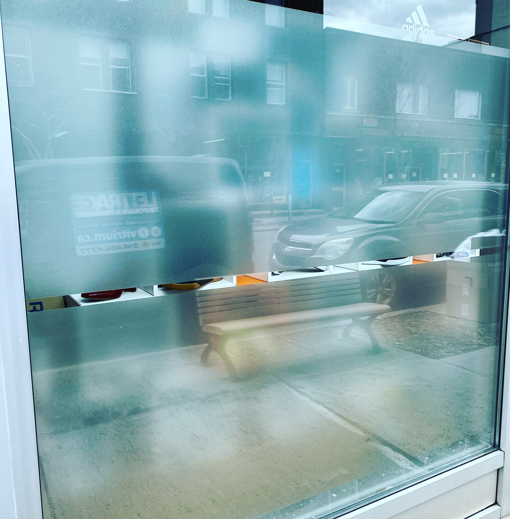 Frosted window film with transparent bands and reflections